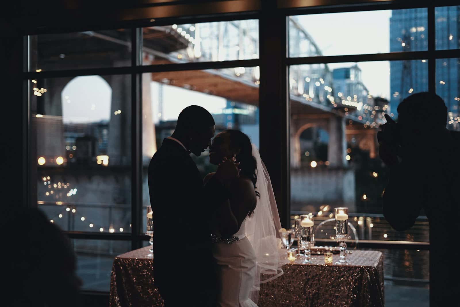 Silhouette of a couple's first dance by the window